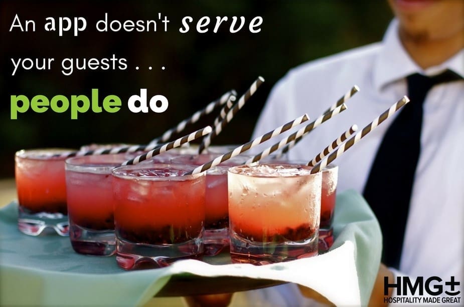 A uniformed server holds a tray of red cocktails with striped paper straws. Text reads: 'An app doesn't serve your guests… people do,' with the HMG+ Hospitality Made Great logo in the bottom right corner.