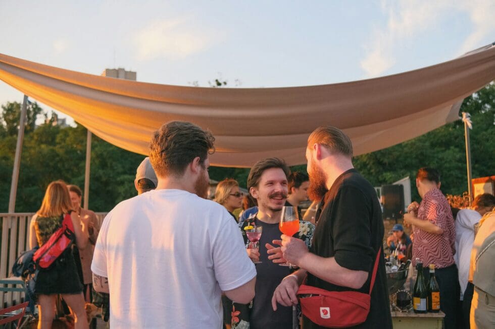 Guests enjoying cocktails at a rooftop private event at sunset, staffed by professional hospitality staff in New York